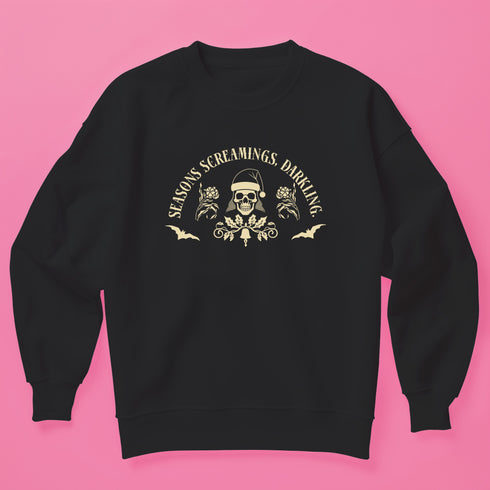 Christmas sweatshirt with "SEASONS SCREAMINGS, DARKLING" text arched over a skull wearing Santa hat. Bats, flowers, and ornate designs surround the skull in vintage-inspired style.